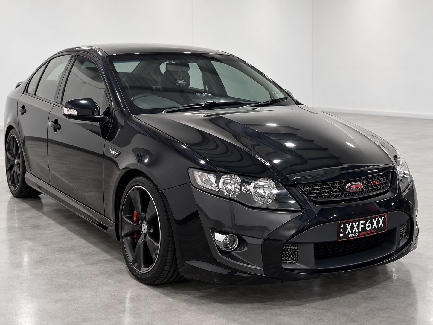 Black Ford performance sedan in a modern showroom